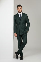 Man wearing green pinstripe double-breasted suit with tailored fit for formal occasions.